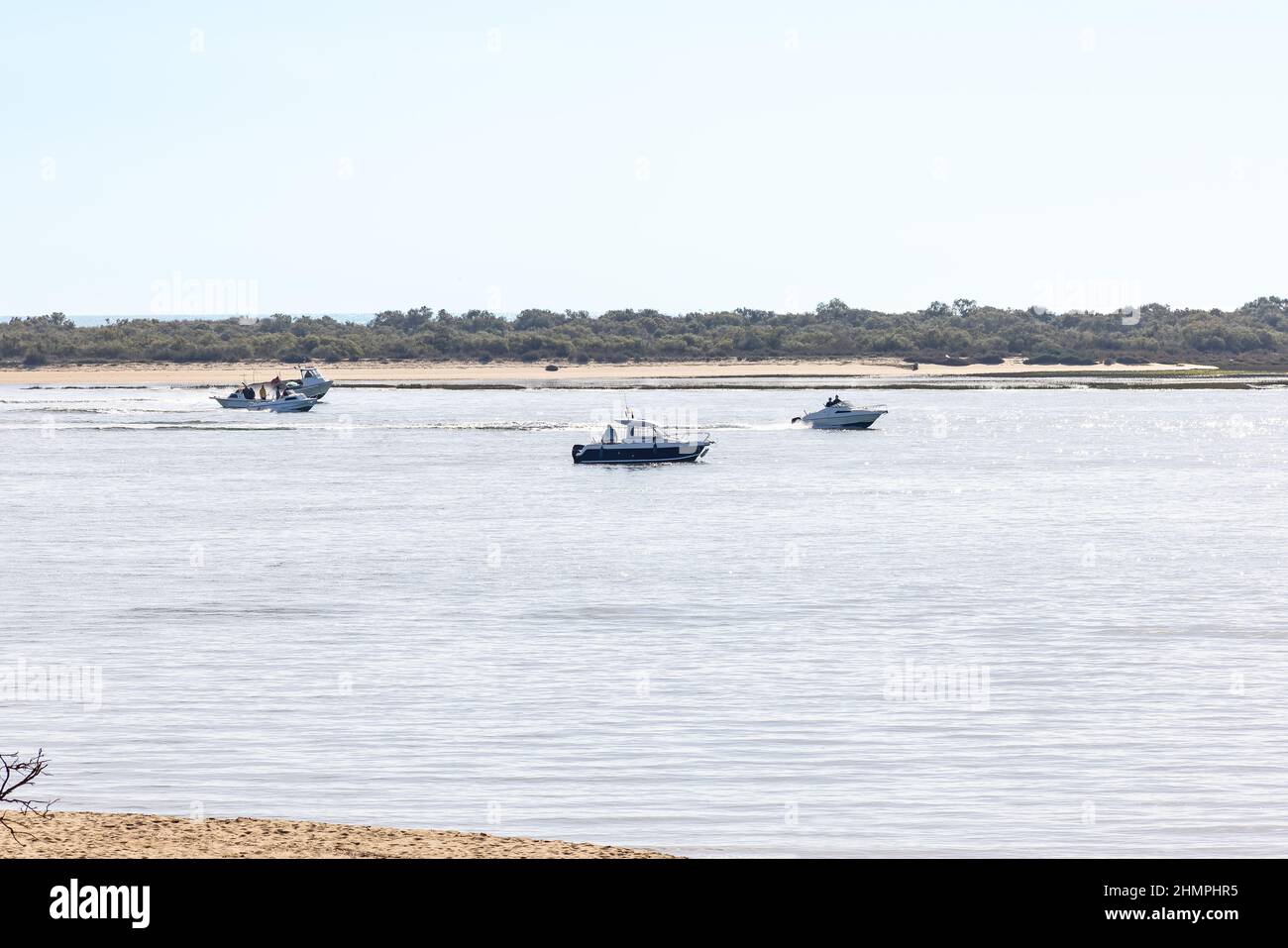 Motor speed boats navigating by the bay of El Portil beach in Punta Umbría, Huelva. Stock Photo