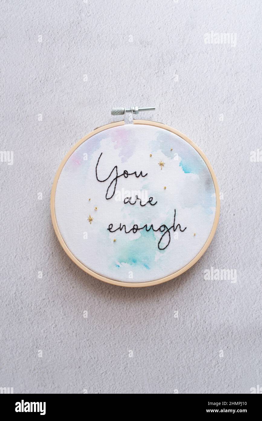 Overhead view of an embroidery hoop with the words you are enough Stock Photo