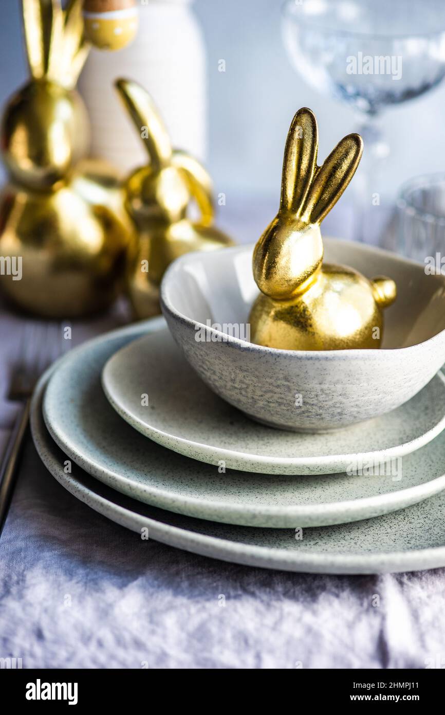 Festive Easter place setting with a golden bunny Stock Photo