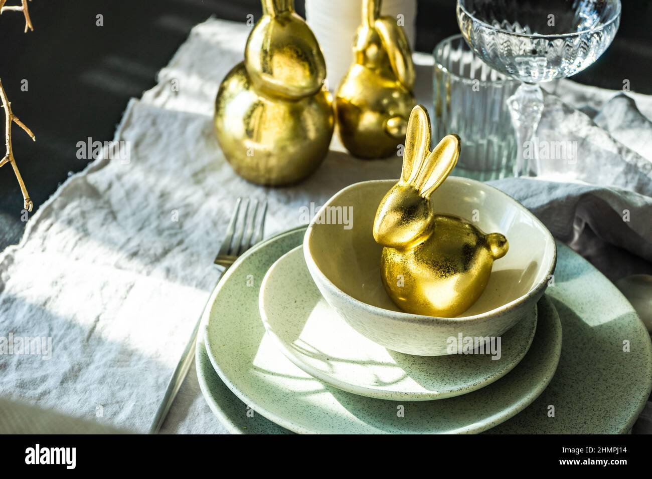 Festive Easter place setting with a golden bunny Stock Photo