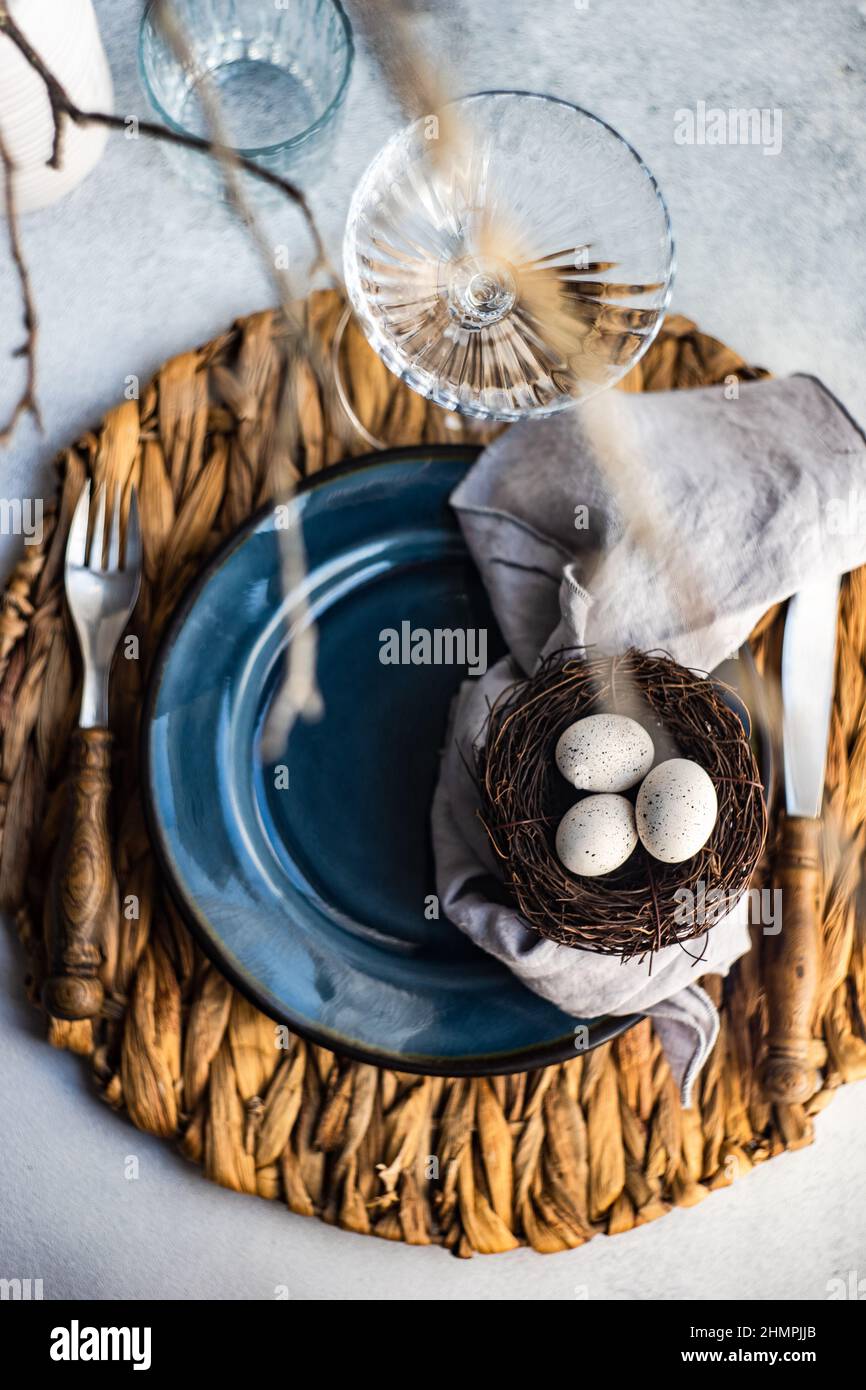 Easter place setting with Easter eggs in a bird's nest Stock Photo