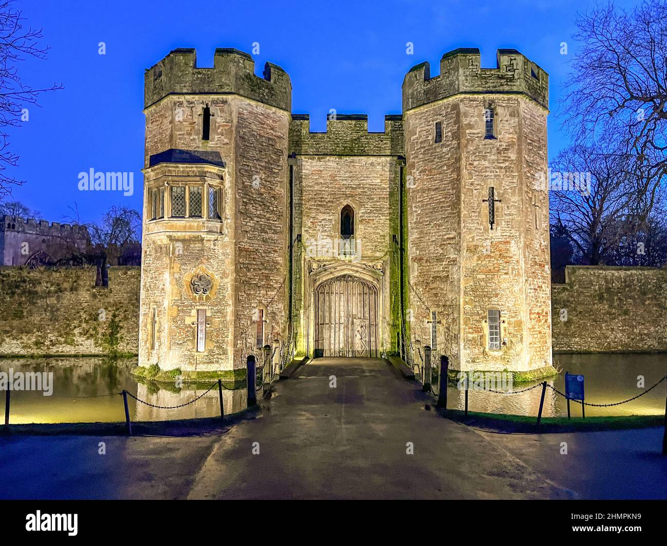 Entrance gate to the Bishops Palace at night being the entrance to the formal gardens in Wells, Somerset, UK. The Bishops Palace was built in the 13th Stock Photo
