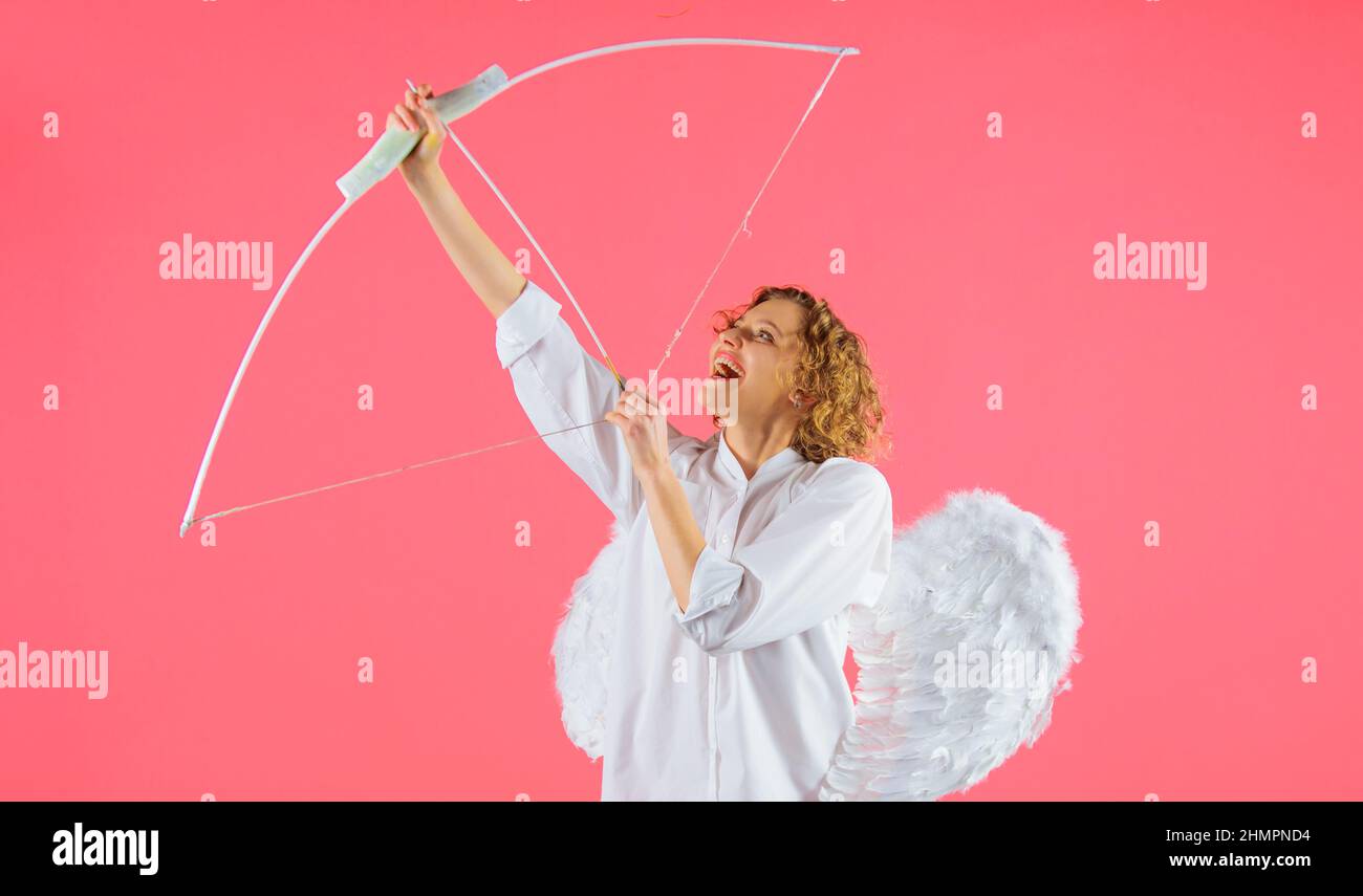 Female angel with bow and arrow. Valentines day cupid with white wings. Arrows of love Stock Photo