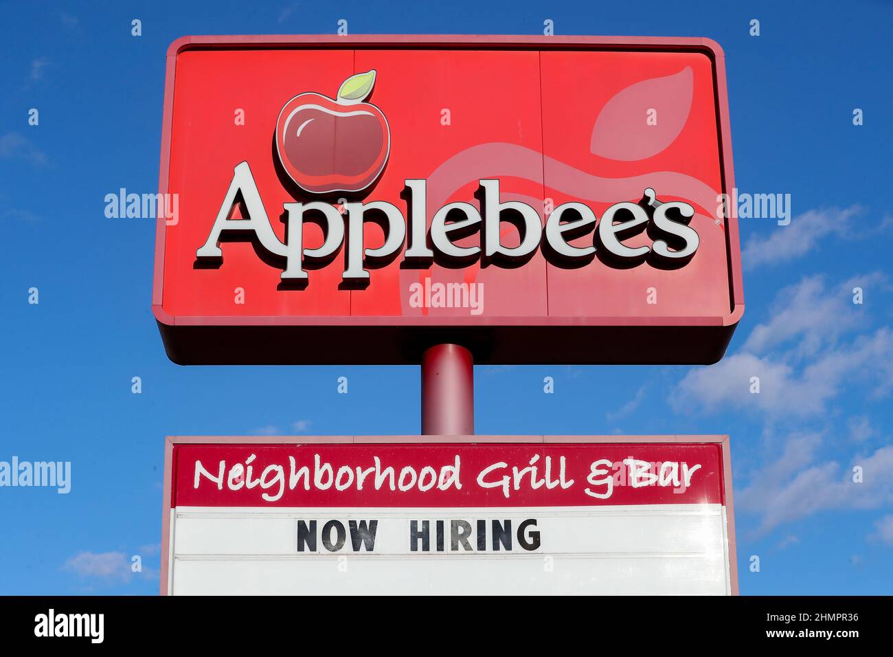 A view of "now hiring" sign and logo Applebee's restaurant.Exterior
