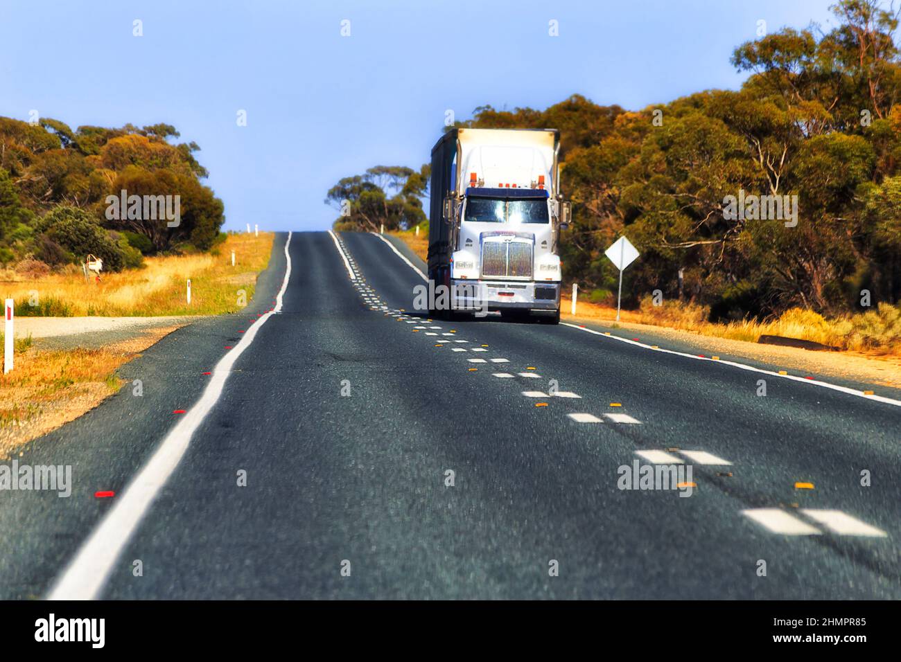 Remote highway in Australian outback - kingdom of heavy vehicle trucks moving cargo around Australia. Stock Photo