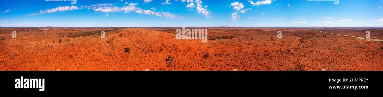 Scenic red soil hill range of Dolo hill rest stop on Barrier highway in outback of Australia - aerial panorama. Stock Photo