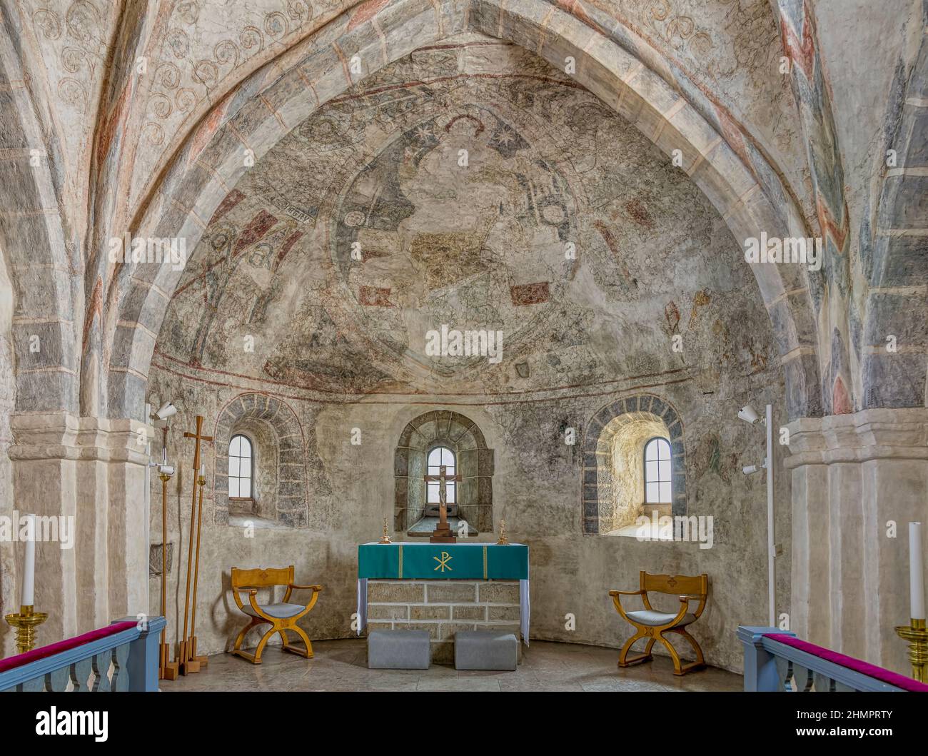 The solemn Choir in Skurup church with a stone altar and a big mural depicting christ in Majesty, the pantocrator, Skurup, Sweden, July 16, 2021 Stock Photo