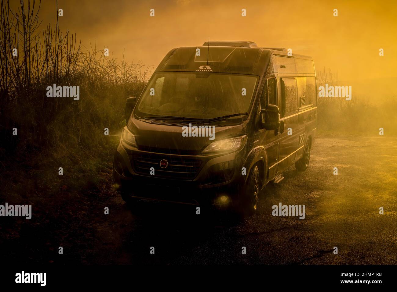 Camper van, rain, sunlight - Stock Image