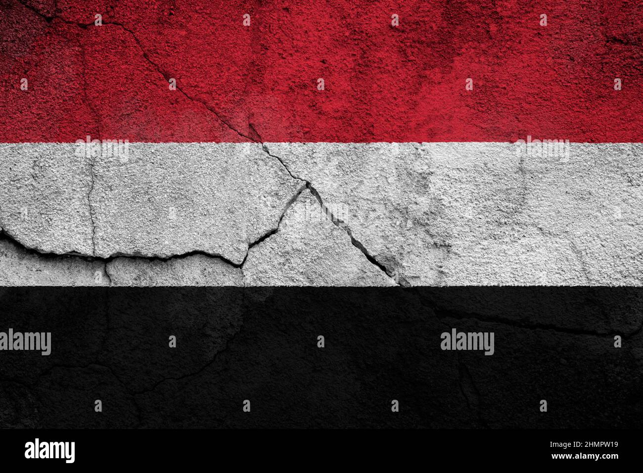 Full frame photo of a weathered flag of Yemen painted on a cracked wall ...