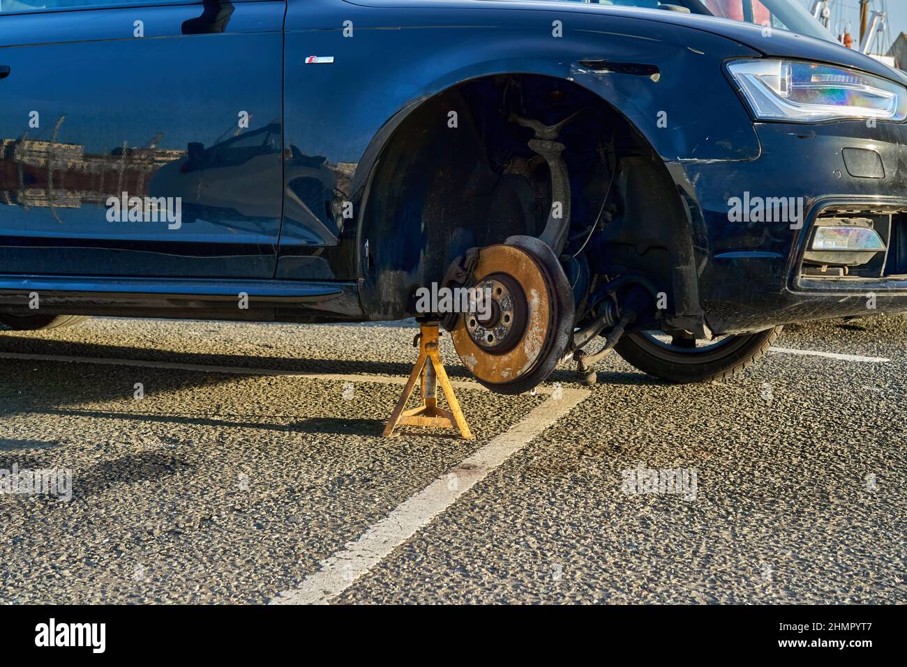 A car is missing a wheel Stock Photo Alamy