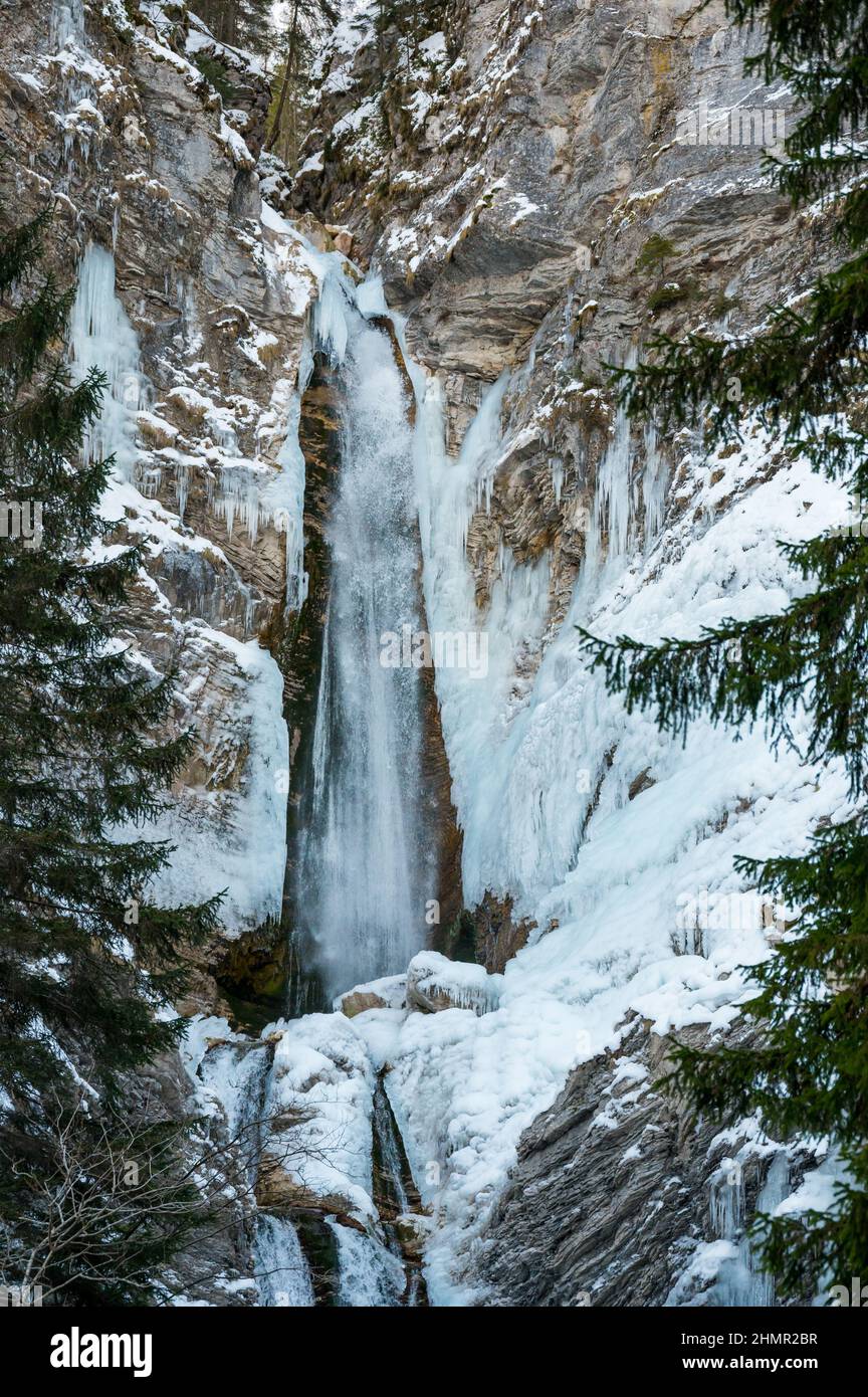 Winter landscape of a frozen waterfall falling in the forest Stock ...