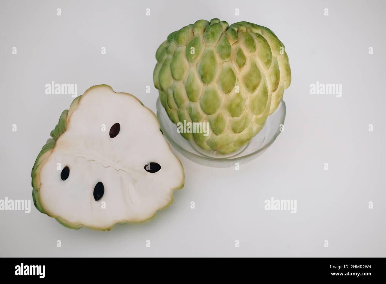 Cherimoya sugar apple eshta fruit cut with black seads, exotic sweet