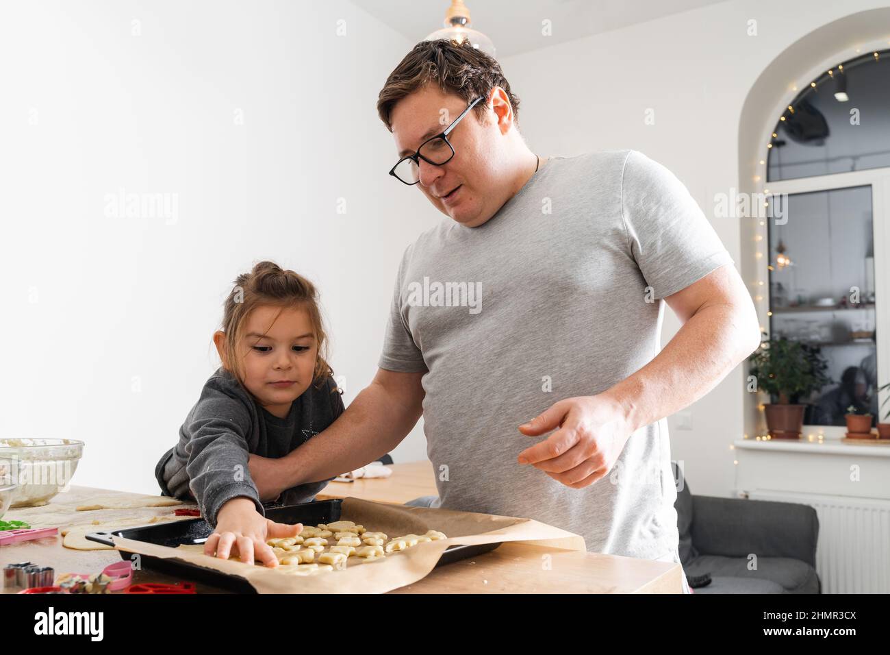 Cropped view of unrecognizable man and his daughter making sweets with ...
