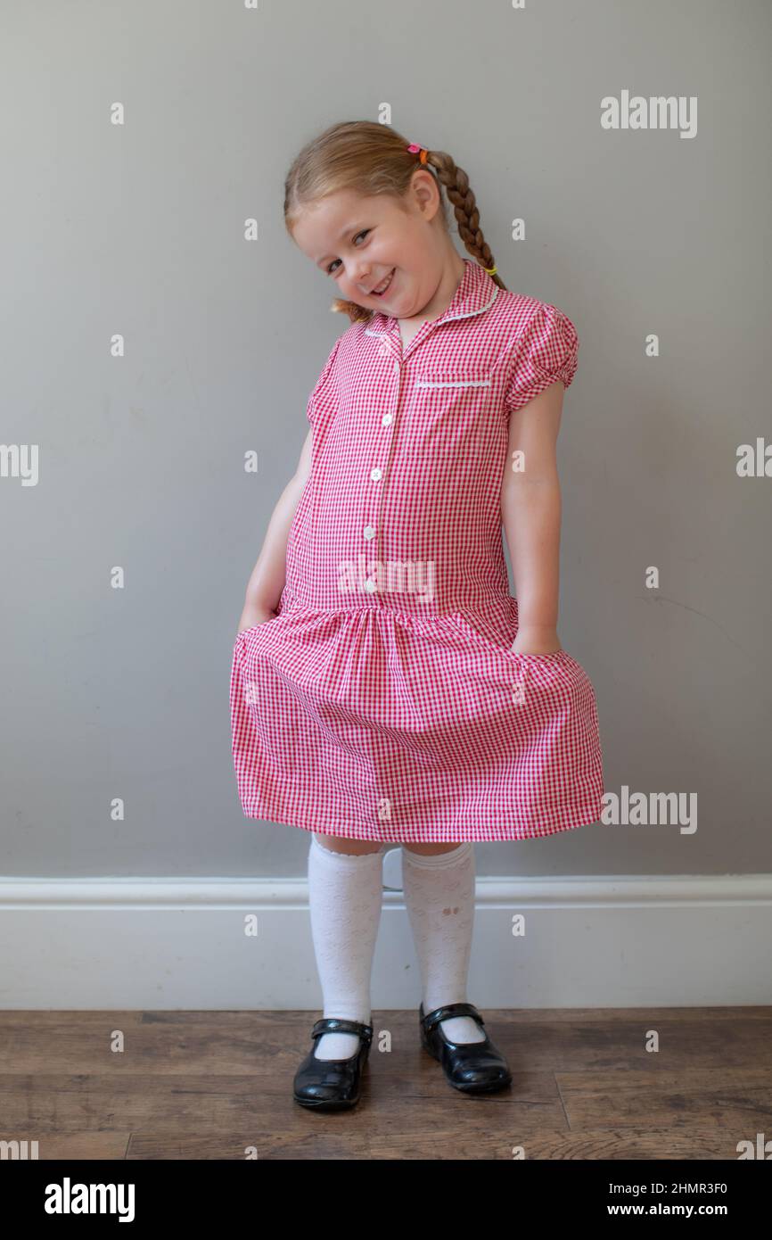 5 year old in her summer school dress, UK Stock Photo