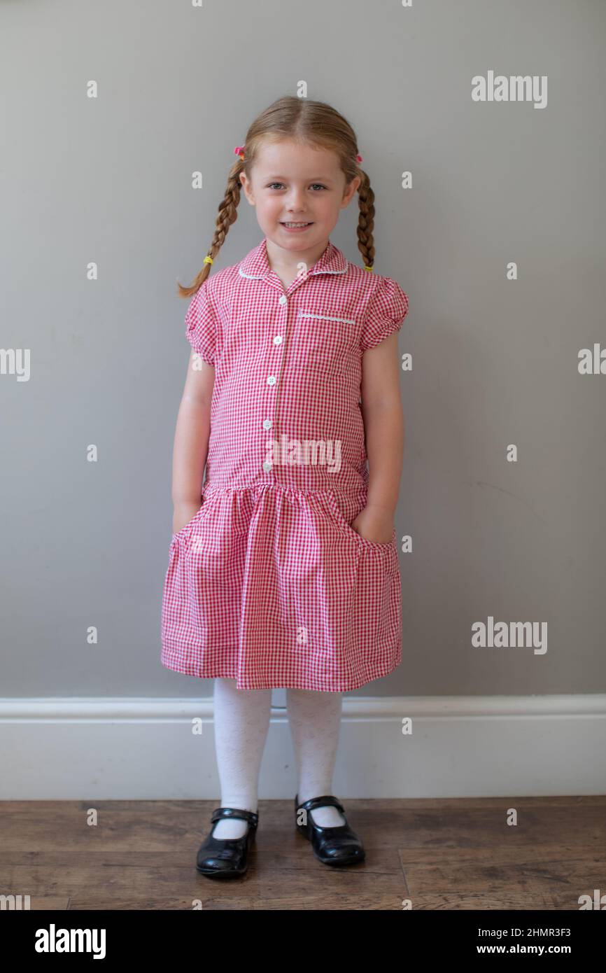 5 year old in her summer school dress, UK Stock Photo