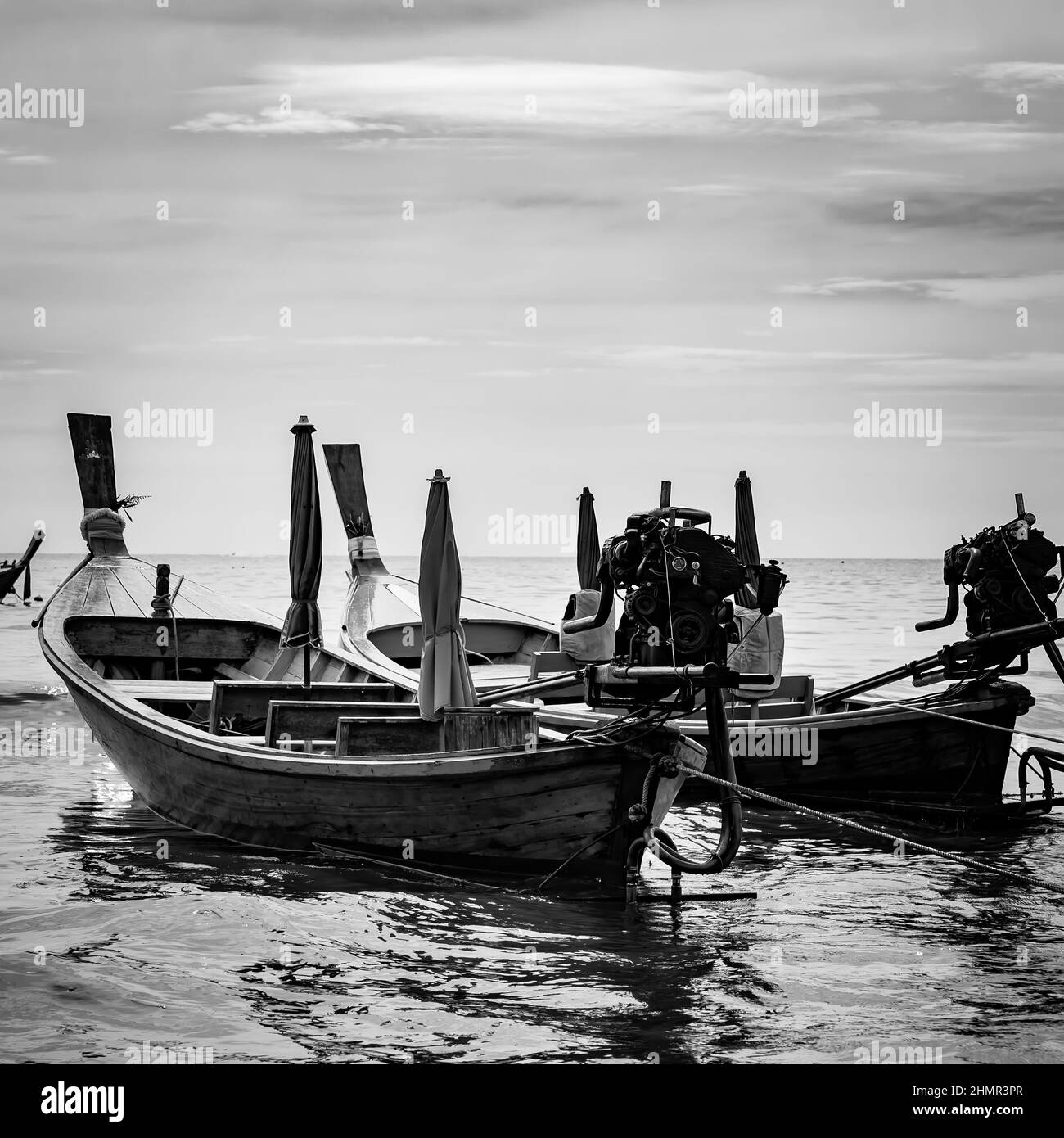 Thai long-tail boats inshore, Phuket, Thailand. Black and white photography, seascape Stock Photo