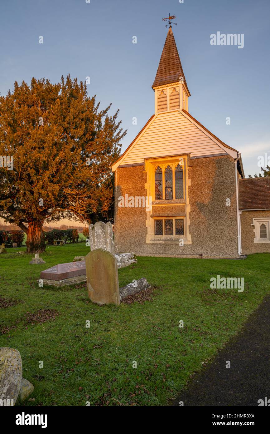 The moon above Saint Margaret's Church Ifield near Gravesend at sunset in winter Stock Photo