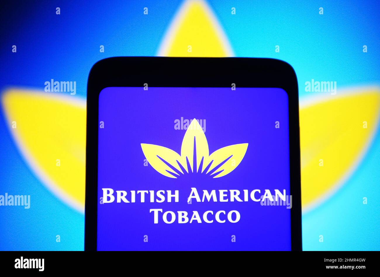 In this photo illustration, a British American Tobacco plc (BAT) logo is seen on a smartphone screen. Stock Photo