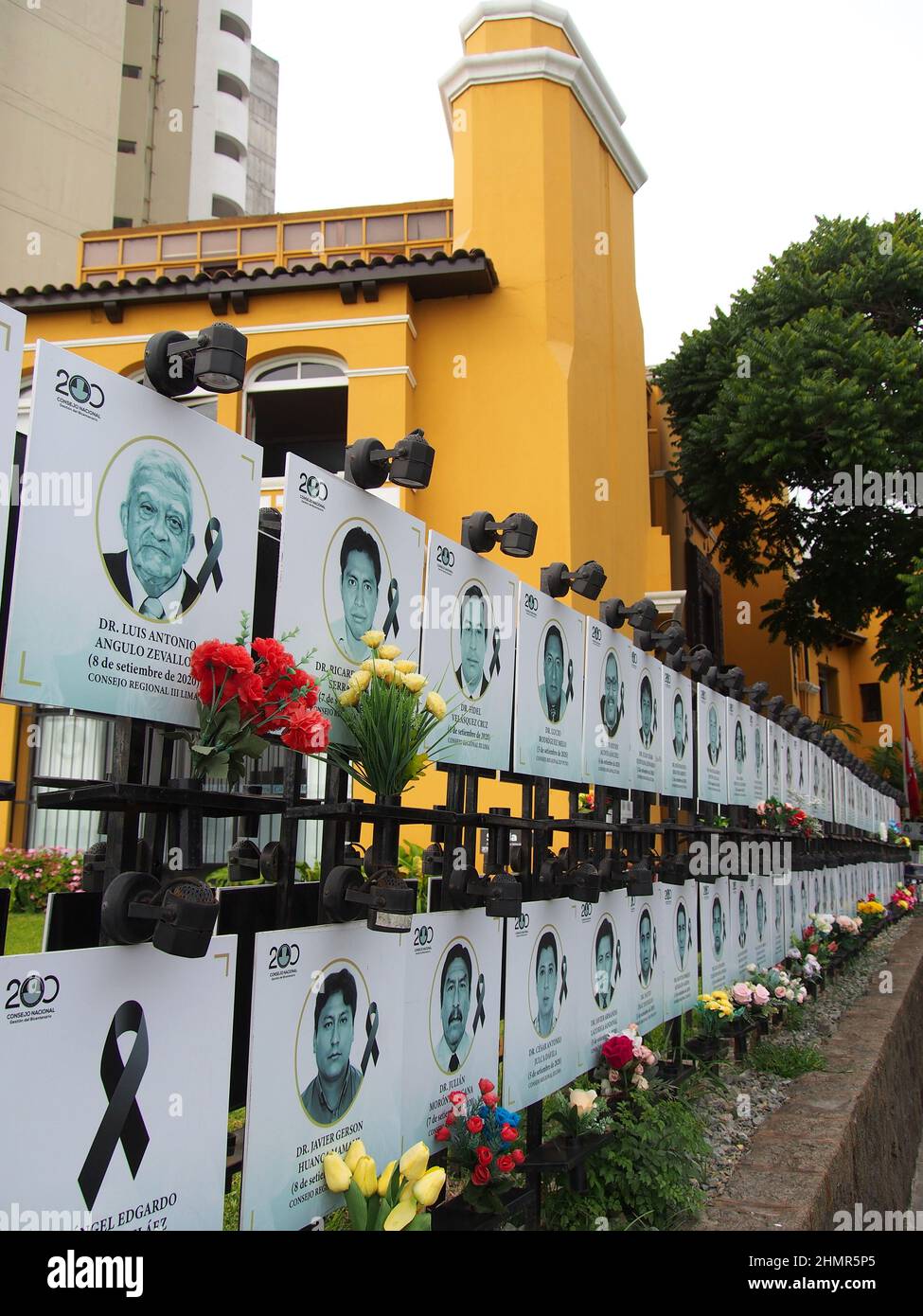 With the decline in infections from the third wave of Covid 19, the pandemic seems to be finally moving away but leaving behind, on the facade of the Peruvian Medical College, as a memorial; hundreds of black ribons and portraits of Peruvian doctors who died on duty when fighting the pandemic. Peru has so far suffered the death of more than 200 thousand citizens due to covid-19.Representatives of the Medicine college give statements in front of a black ribbon and portrait photos of deceased on duty Peruvian doctors, during the coronavirus pandemic (Covid-19). Stock Photo