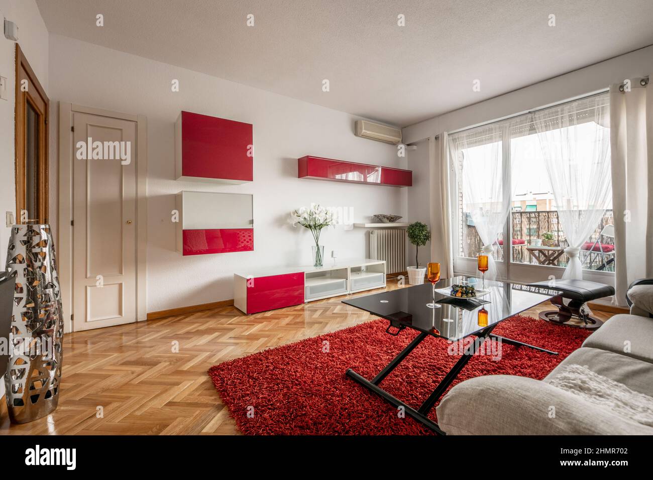 Living room decorated with red furniture and red carpet, terraces with