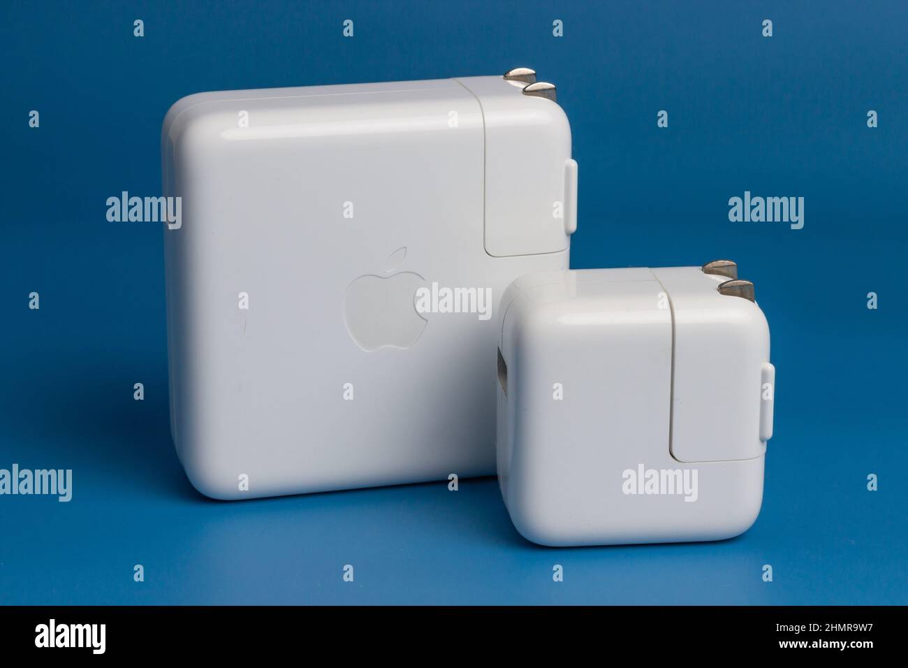 Manila, Philippines - February 12, 2022: Apple MacBook Pro and Ipad Air charger Isolated in Blue Background Stock Photo