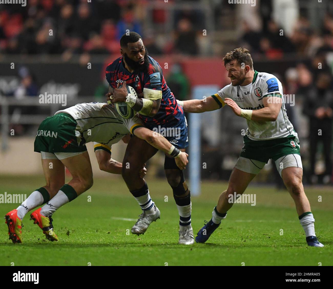 Henry Purdy of Bristol Bears, tackled by Henry Arundel and James Stokes of London Irish, Stock Photo