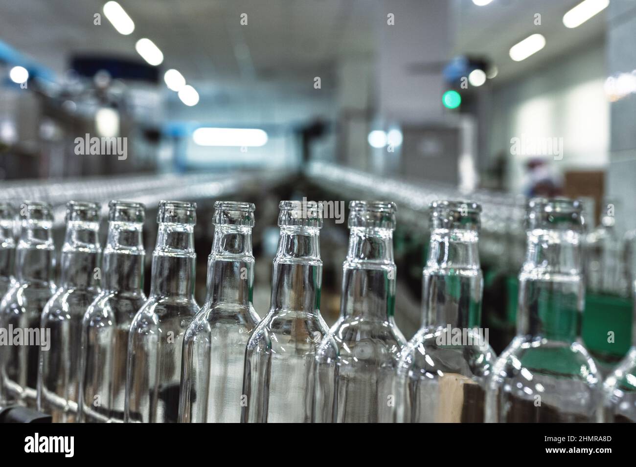 Conveyor belt carries clean glass bottles for alcohol drinks Stock