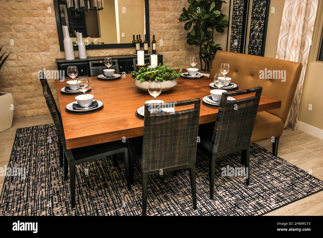 Square Wooden Dining Room Table With Eight Place Settings Stock Photo