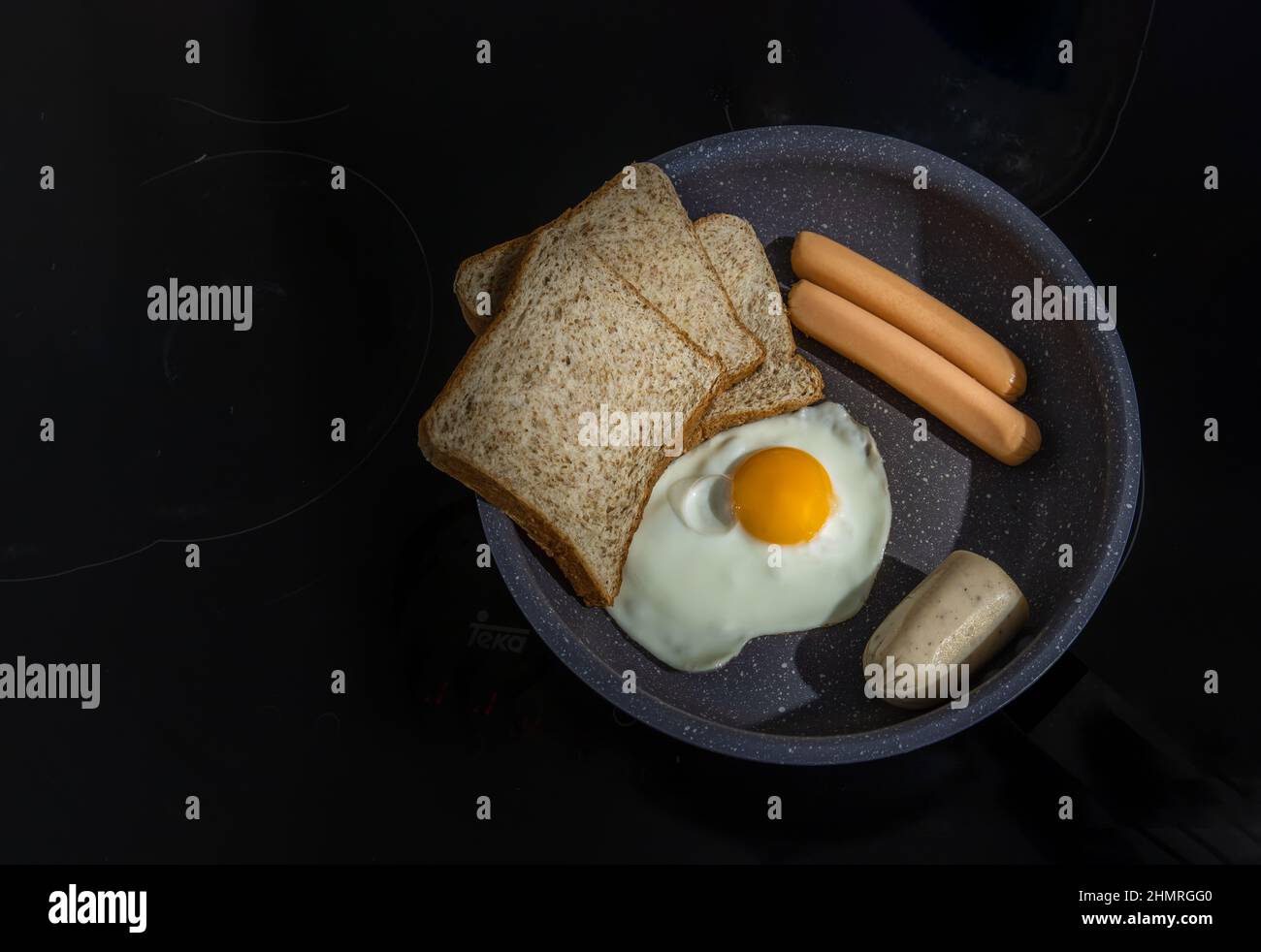 Preparing Breakfast in Cooking pan with Fried egg, Fried sausages, Breads and Vietnamese pork. Copy space, Selective focuse. Stock Photo