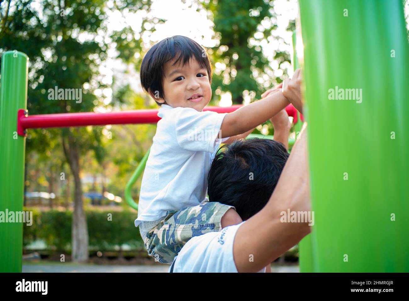 Little Boy Riding On The Neck Of Dad While Enjoying In Outdoor 