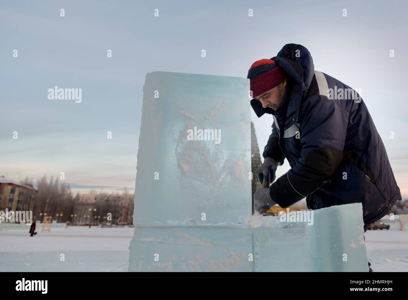 Worker with a chisel in his hand at a construction site Stock Photo