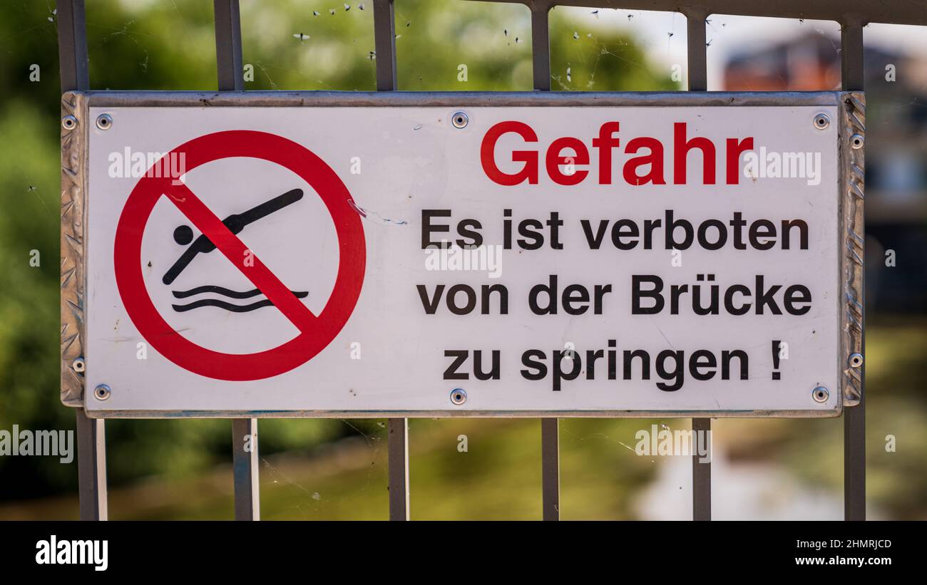 Sign: Gefahr Es ist verboten von der Brcke zu springen. German for: Danger, Jumping from the bridge is forbidden Stock Photo