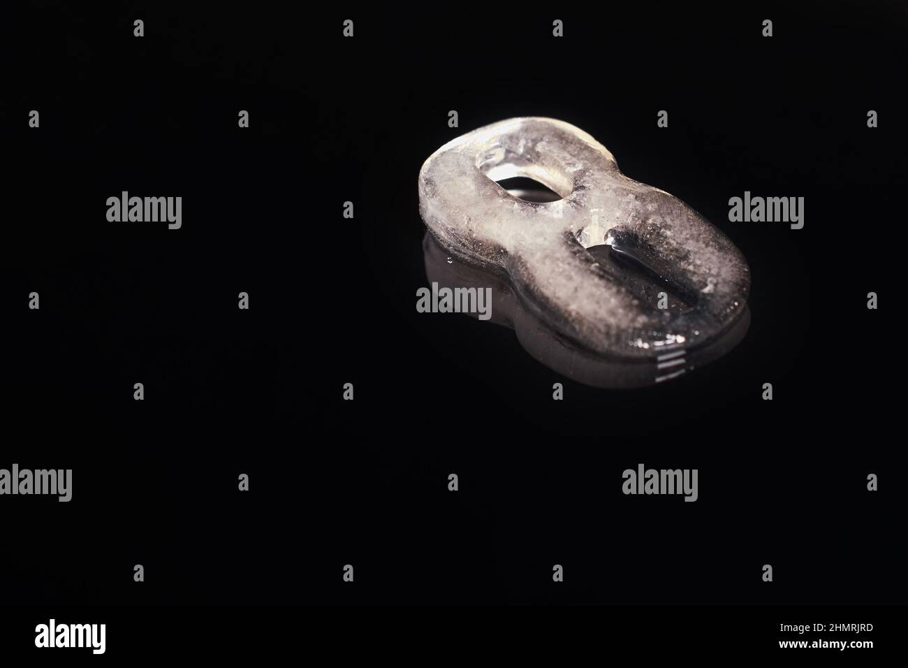 Melted Eight A melted ice figure Eight on a black background with a reflection Stock ...