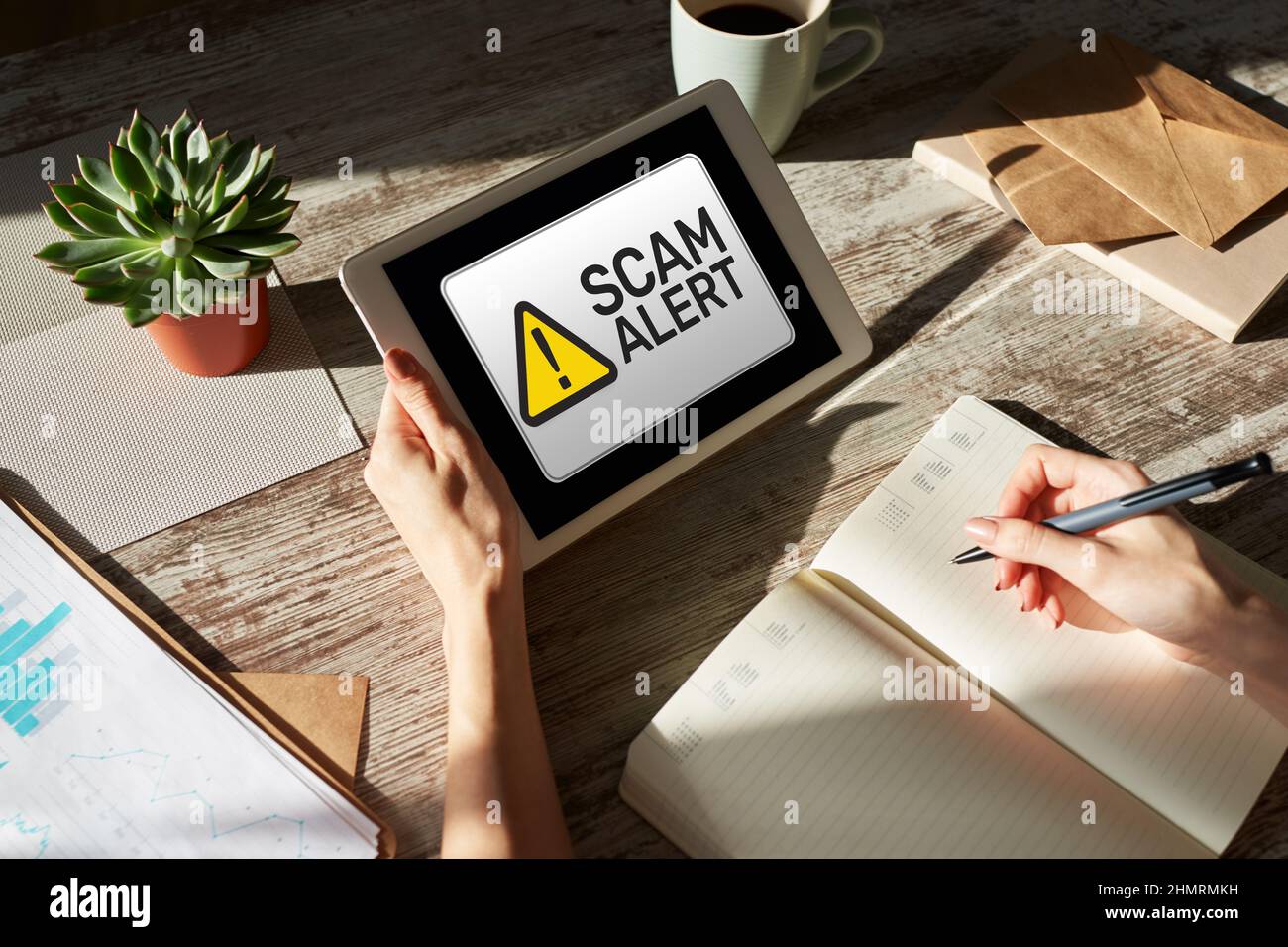 Scam alert detecting warning. Notification on device screen. Stock Photo