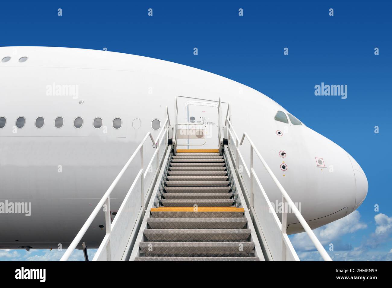 passenger boarding stairs leading to big jet plane entrance Stock Photo