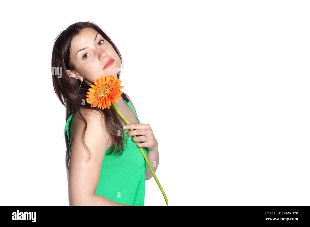 Portrait of a sad woman holding gerbera flower, isolated over white background Stock Photo
