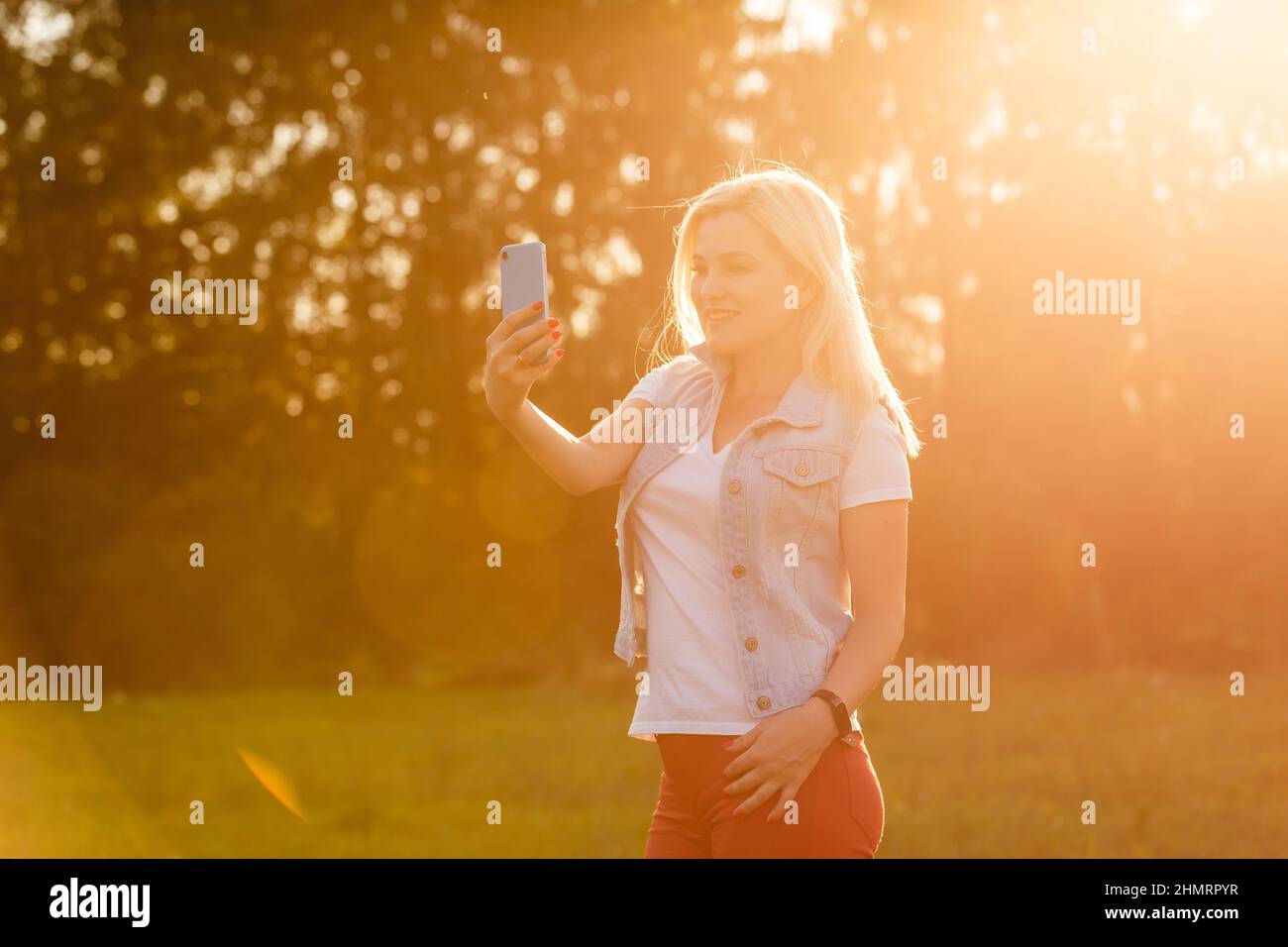 Beautiful young woman selfie in the park Stock Photo - Alamy