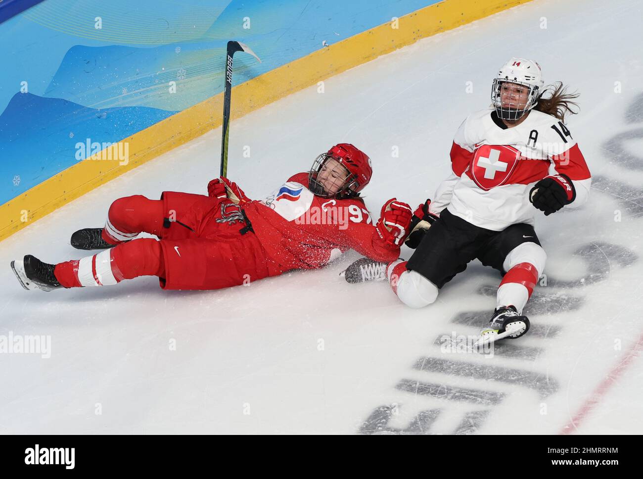 Beijing, China. 12th Feb, 2022. Anna Shokhina (L) of ROC vies with Evelina Raselli of Switzerland during the ice hockey women's quarterfinals between Switzerland and ROC at Wukesong Sports Centre in Beijing, capital of China, Feb. 12, 2022. Credit: Meng Yongmin/Xinhua/Alamy Live News Stock Photo