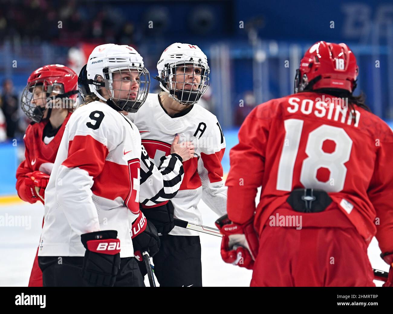 Beijing, China. 12th Feb, 2022. Evelina Raselli (3rd L) of Switzerland argues with Olga Sosina (1st R) of ROC during the ice hockey women's quarterfinals between Switzerland and ROC at Wukesong Sports Centre in Beijing, capital of China, Feb. 12, 2022. Credit: Song Yanhua/Xinhua/Alamy Live News Stock Photo