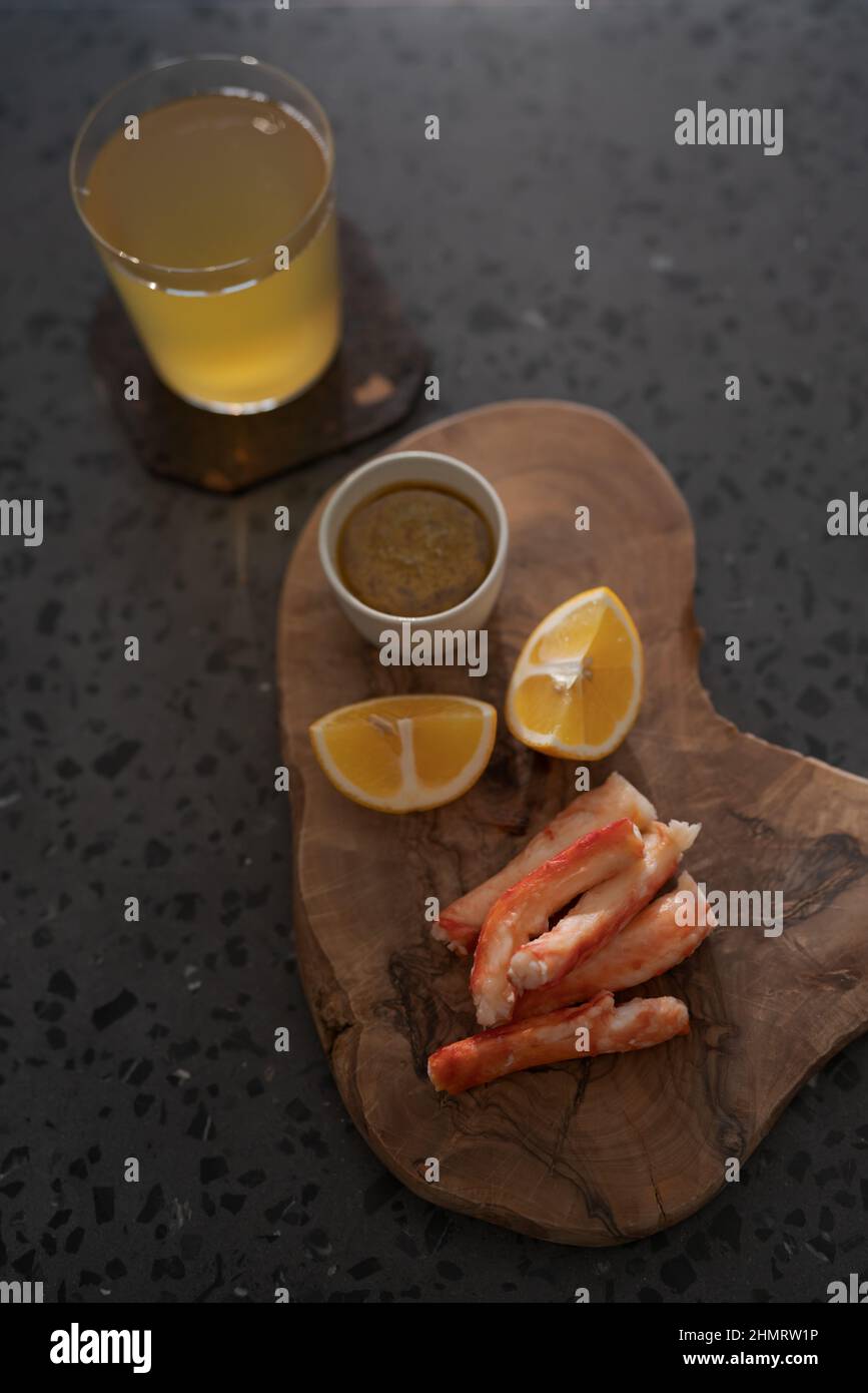 Delicious peeled crab legs with lemon and ginger beer, shallow focus