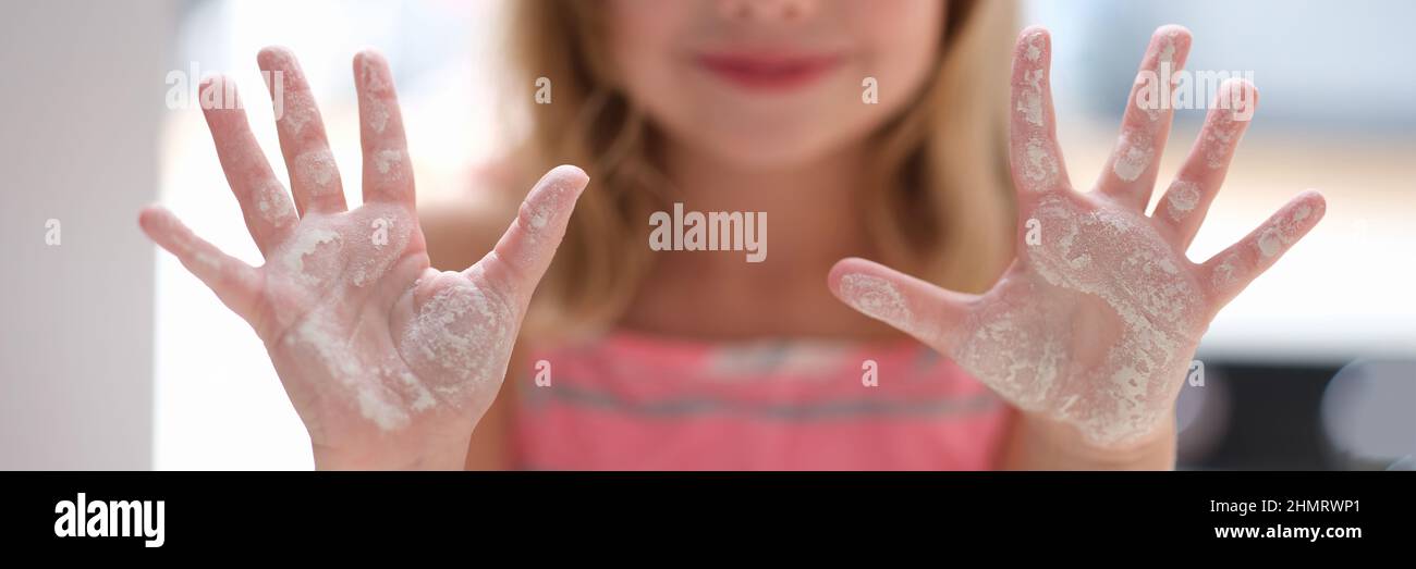 Little girl shows hands in flour. Cooking class for children Stock Photo