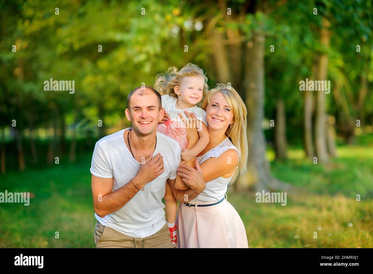 Happy family in a beautiful spring park, healthy outdoor recreation Stock Photo