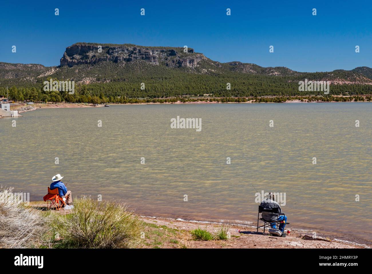 Anglers at Wheatfields Lake, unnamed plateau in distance, Chuska Mountains, near Tsaile, Navajo Nation, Arizona, USA Stock Photo