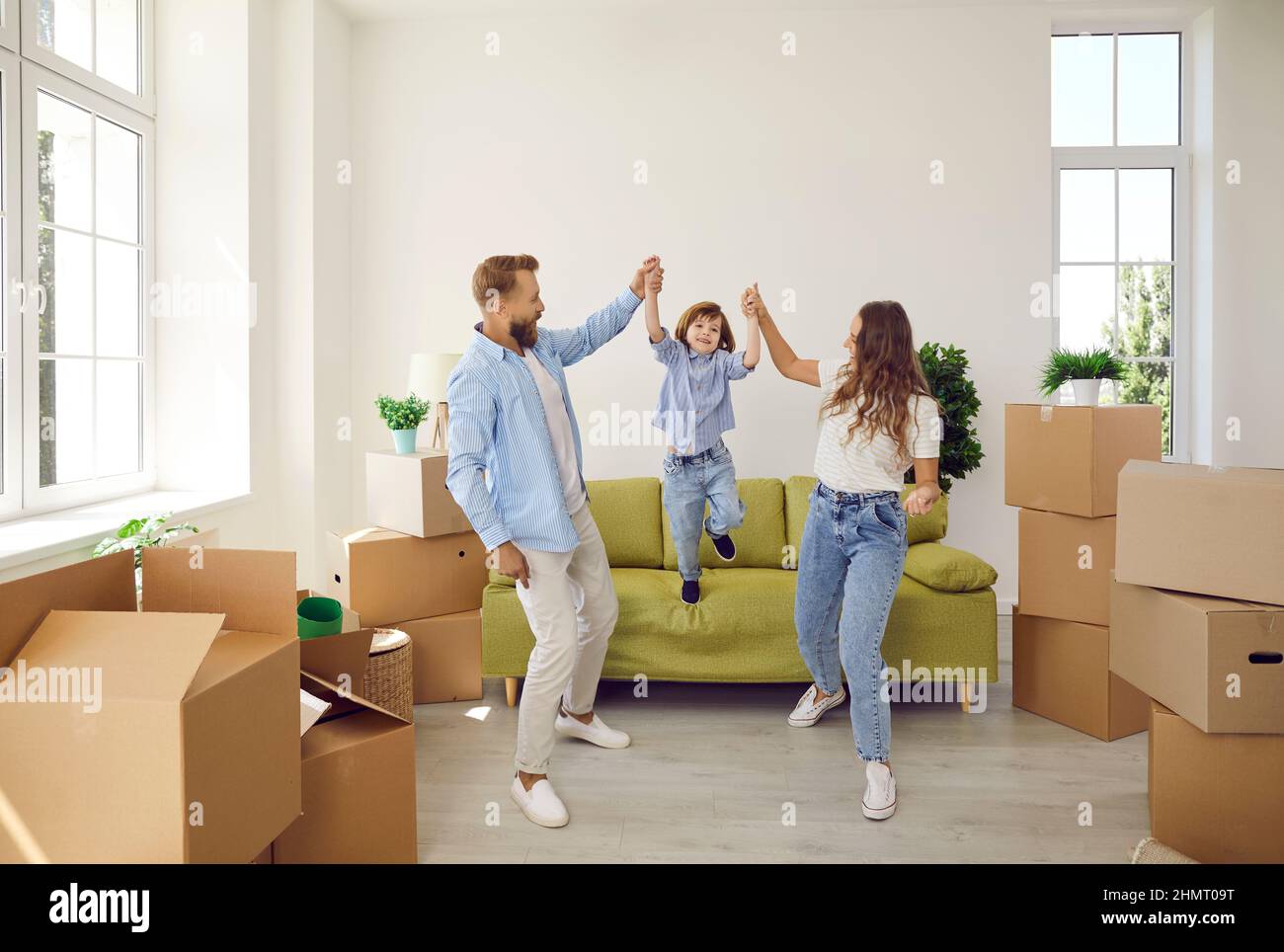 Happy family with kid celebrate relocation to new home Stock Photo