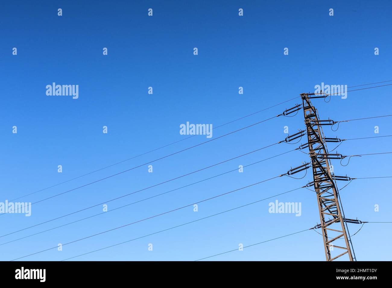 Electricity pylon power pole high voltage against blue sky Stock Photo