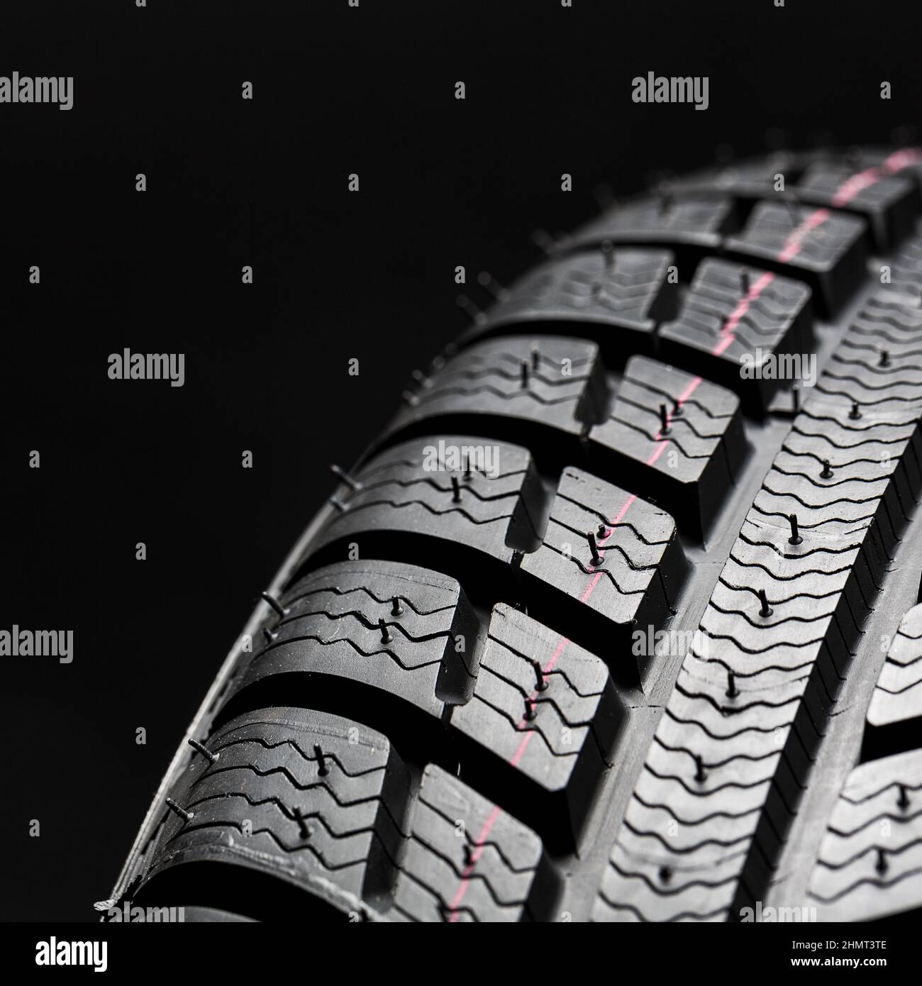 Winter Car tires close-up wheel profile structure on black background Stock Photo