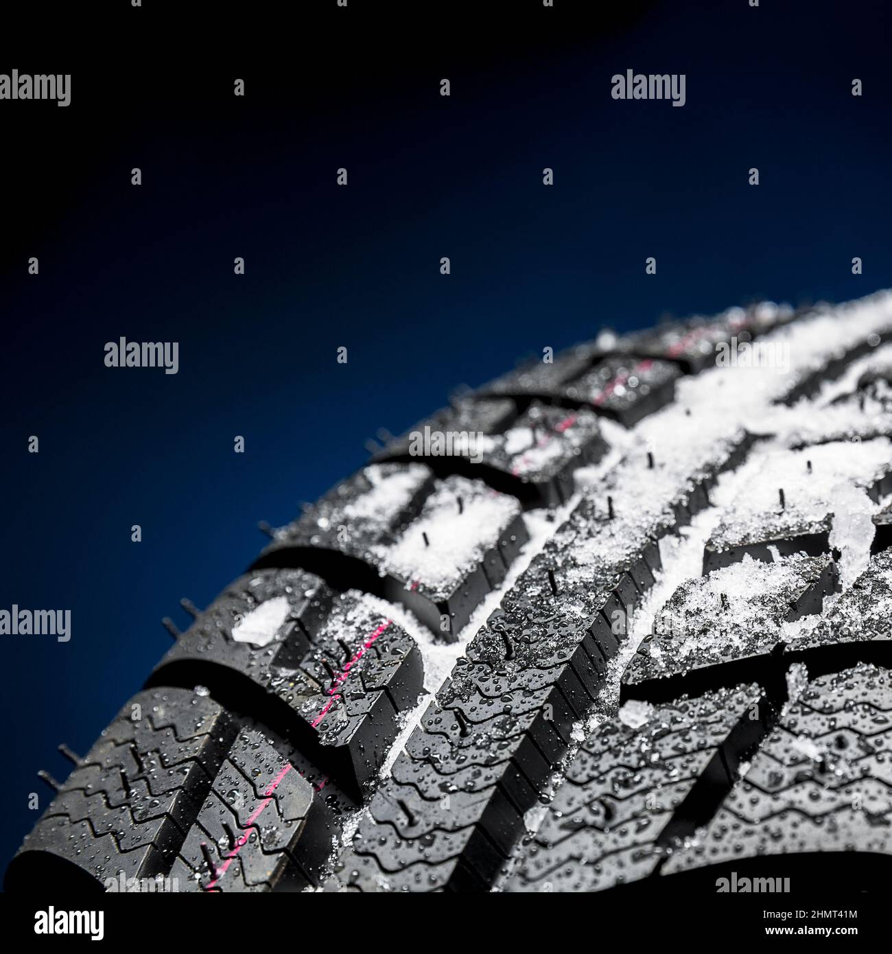 Winter Car tires with snow closeup wheel profile structure on black
