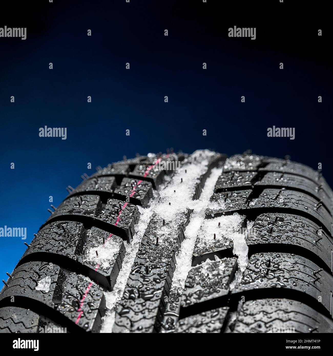 Winter Car tires with snow closeup wheel profile structure on black