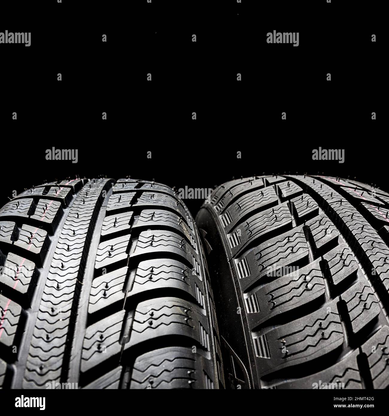 Car tires close-up Winter wheels profile structure on black background Stock Photo