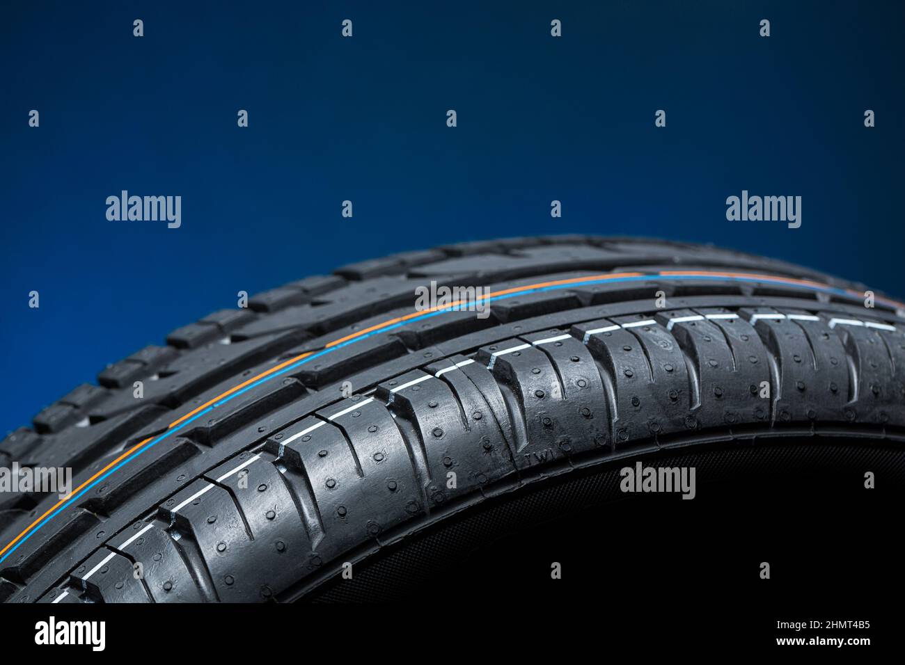 Car tire on black blue bakground Stock Photo